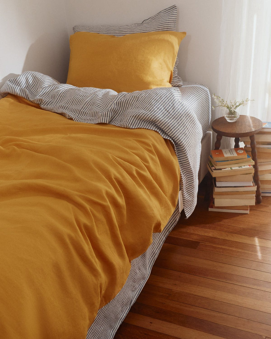 Marigold and Lemon Yellow kids linen duvet set on a single bed