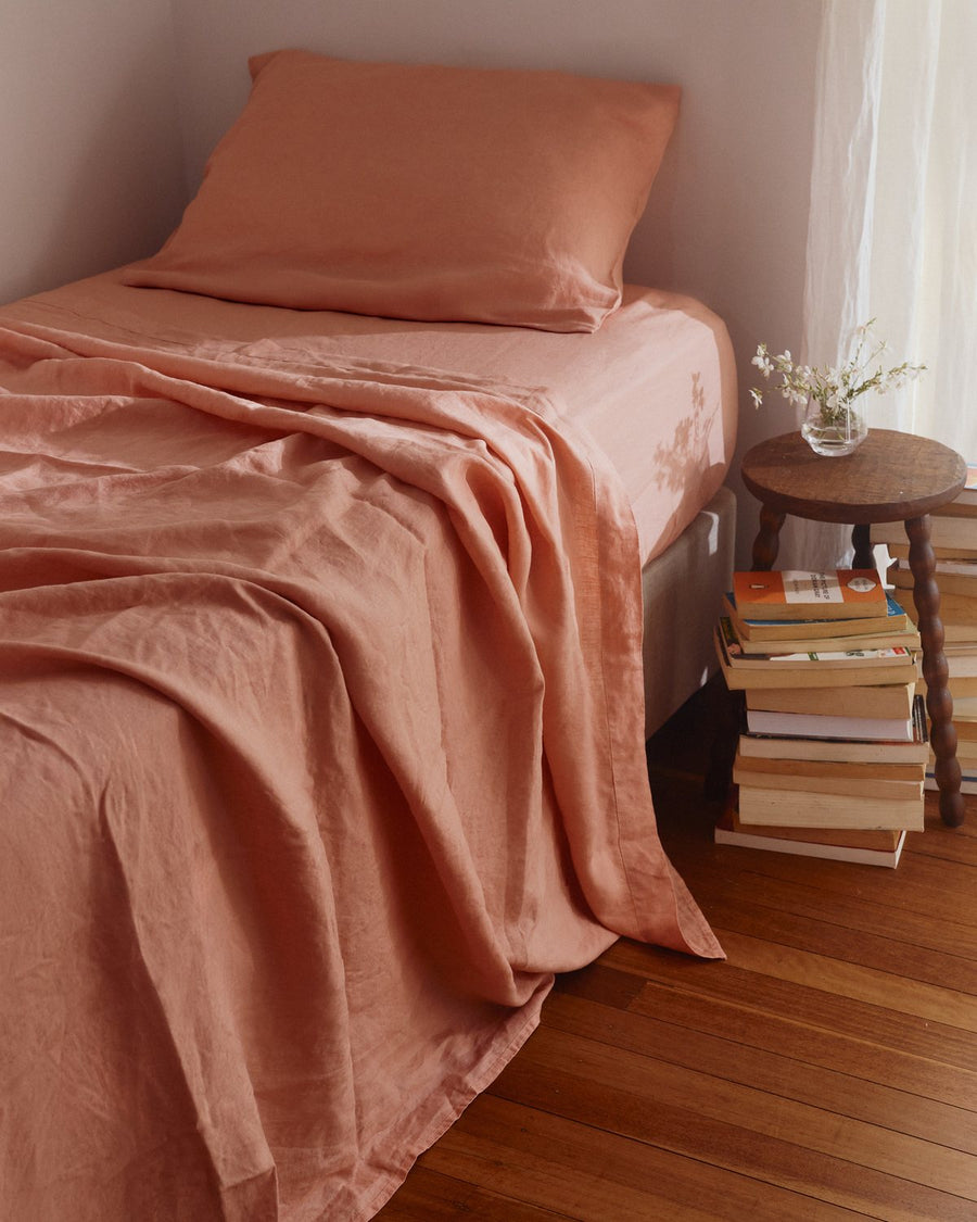Blush kids linen sheet set on a single bed