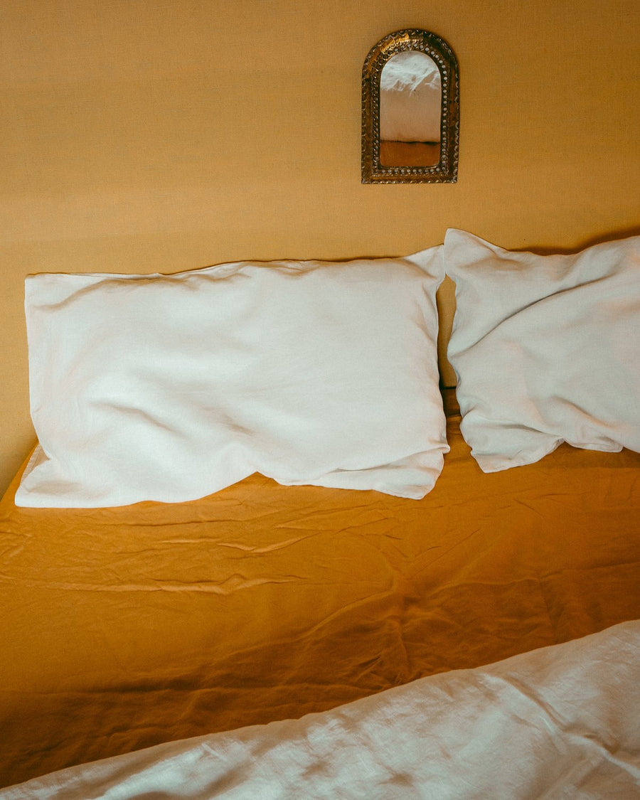 Cumulus linen pillow slips and duvet on a made bed