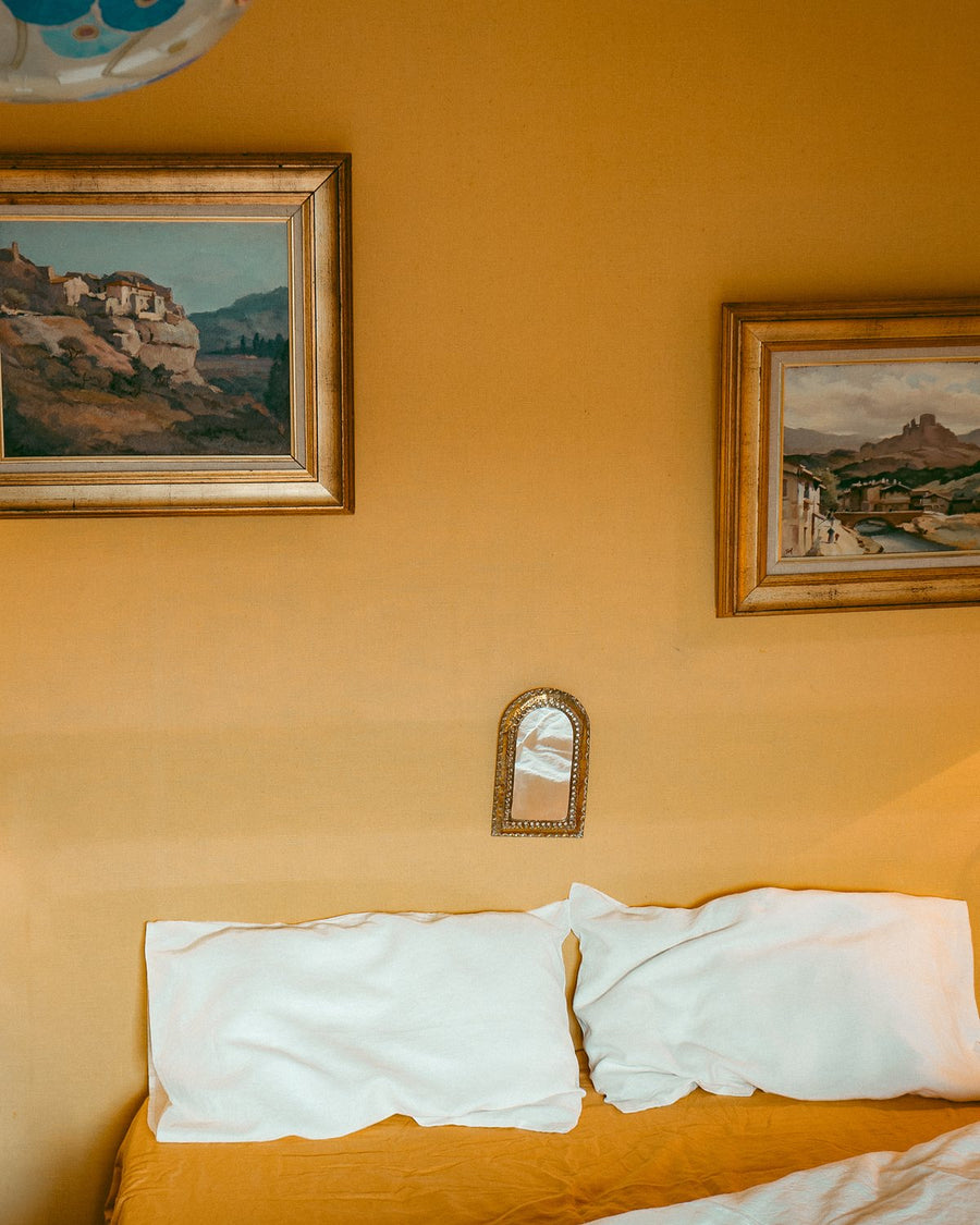 Cumulus white linen pillow slips on a Marigold bed