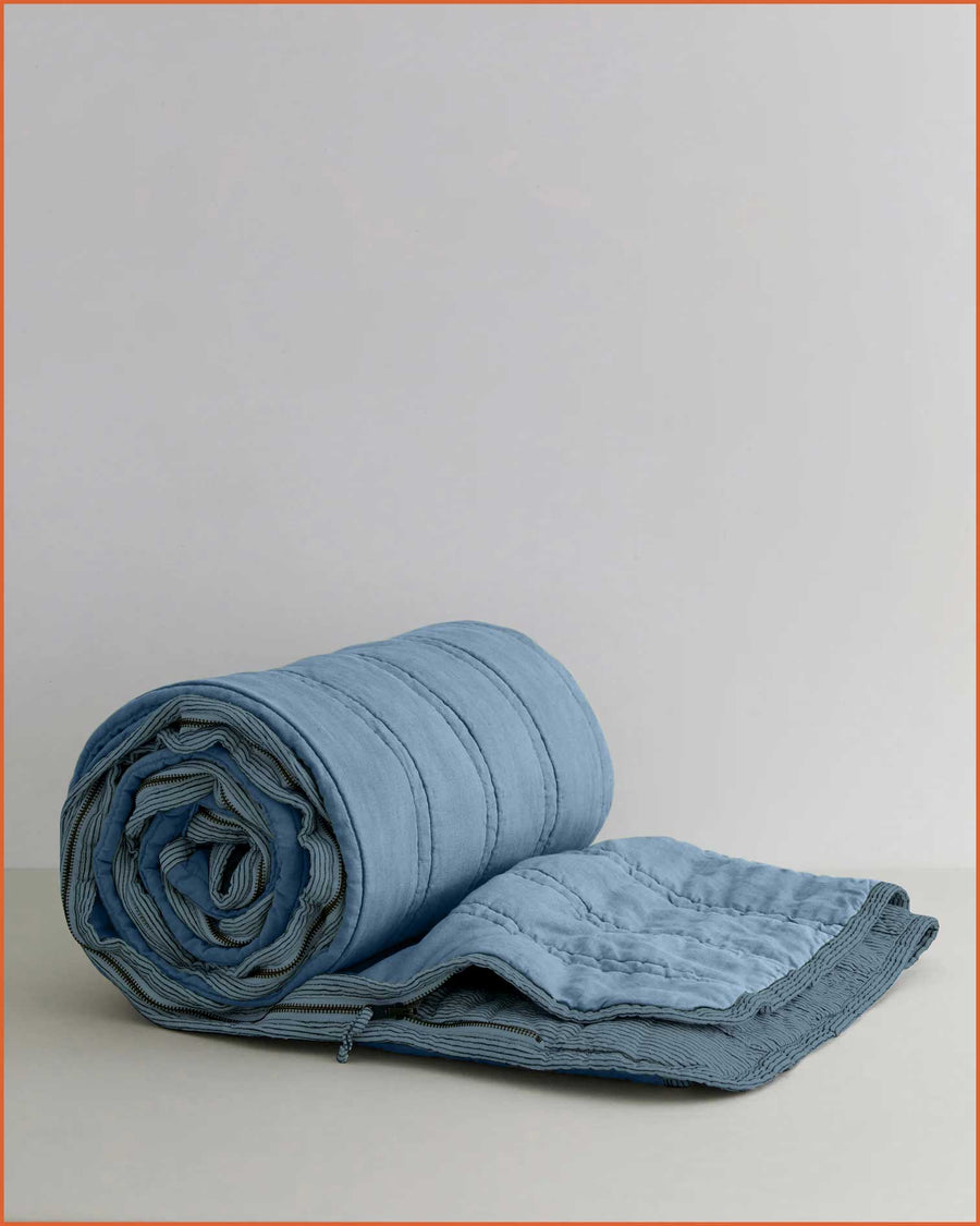 Linen sleeping bag in Ocean & Lake Blue laid out