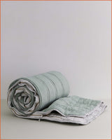 THE QUILTED SLEEPING BAG · SAGE & MINI STRIPE ·